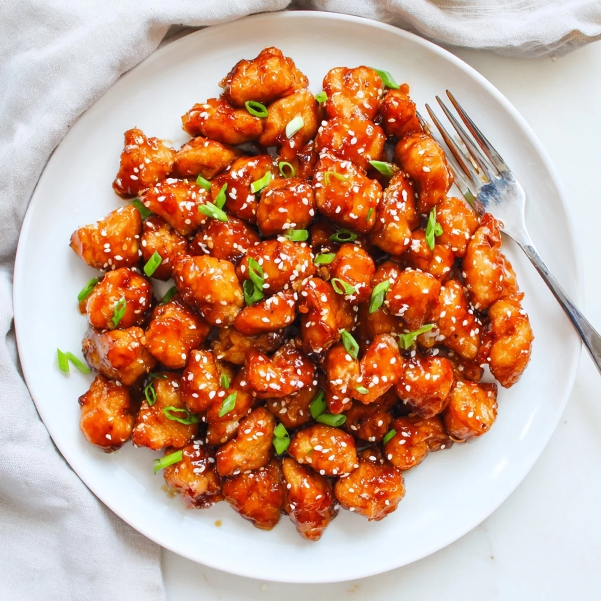 Appetizing bite-sized chicken drizzled with sweet and spicy honey Sriracha glaze.  