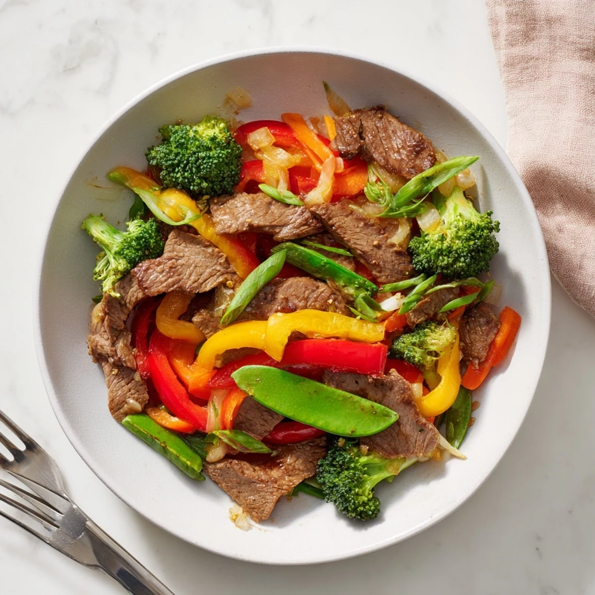 Tender beef and vegetable stir-fry in garlic sauce, bright and flavorful for dinner.  