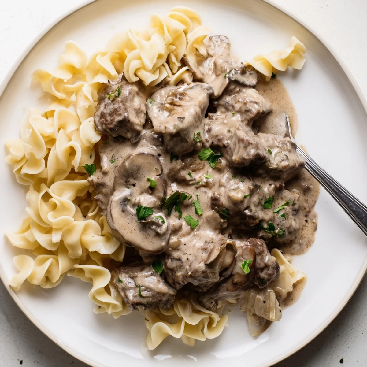Hearty slow cooker beef stroganoff features rich flavors of mushrooms and sour cream.  
