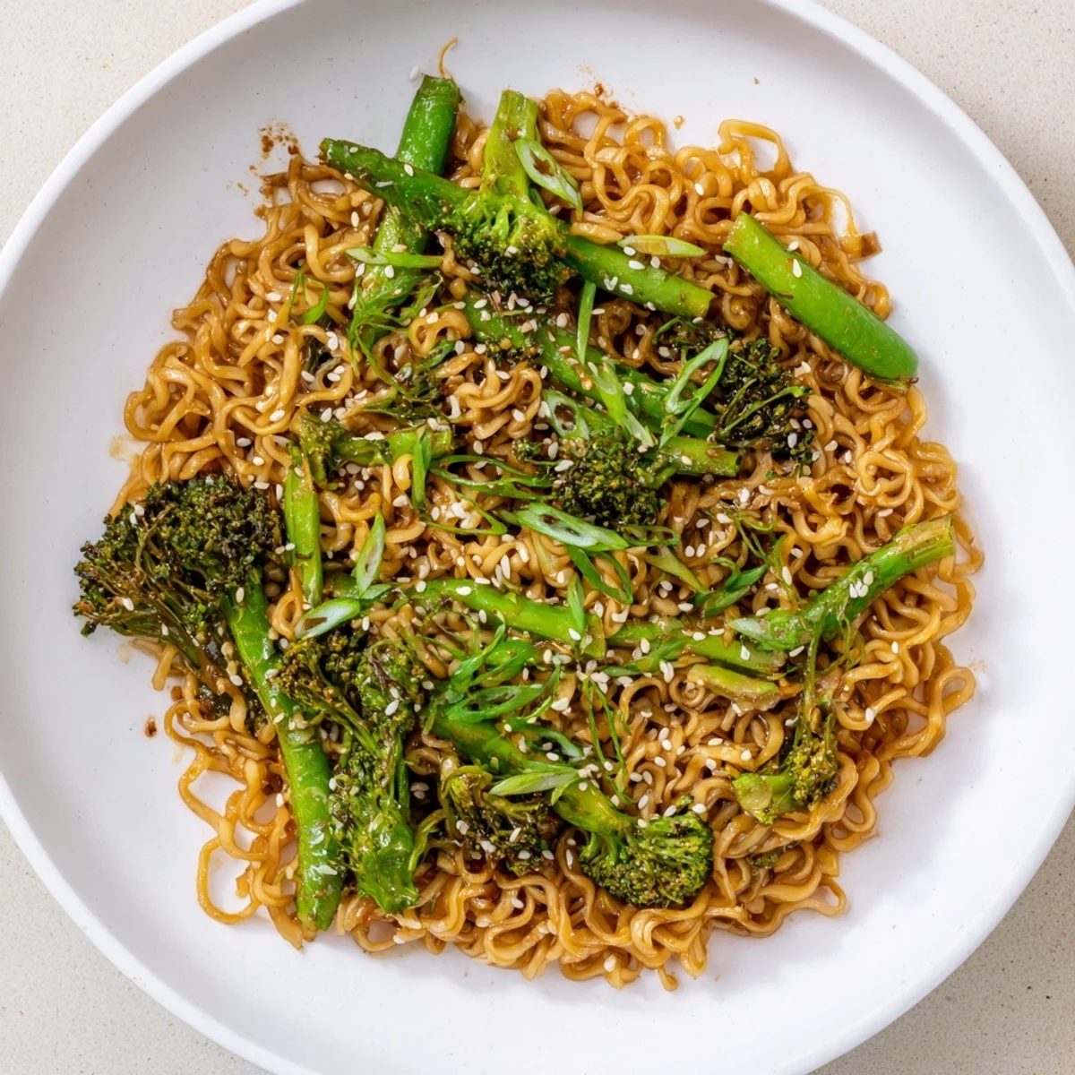 Steaming bowl of Ramen Noodle Stir-Fry Remix, colorful vegetables glistening in a savory sauce.