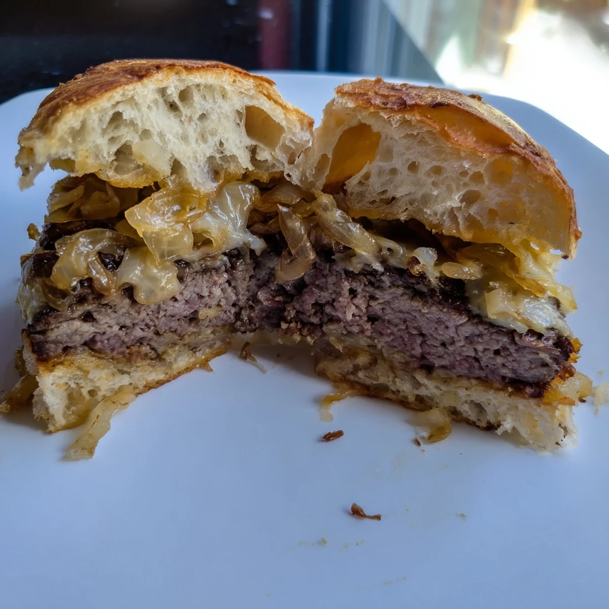 Golden-brown patty melt skillet with oozing Swiss cheese, onions and beef, ready to enjoy at the diner.