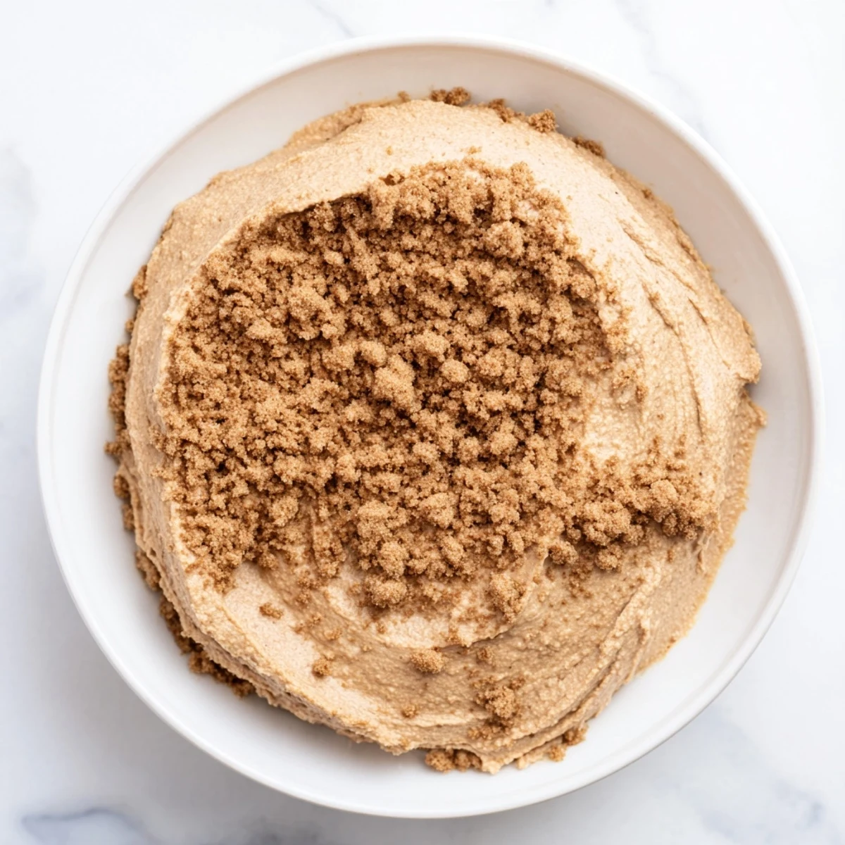 Rich, spiced Quick Christmas Cookie Butter Spread in a spoon, ready to taste test this easy dessert.