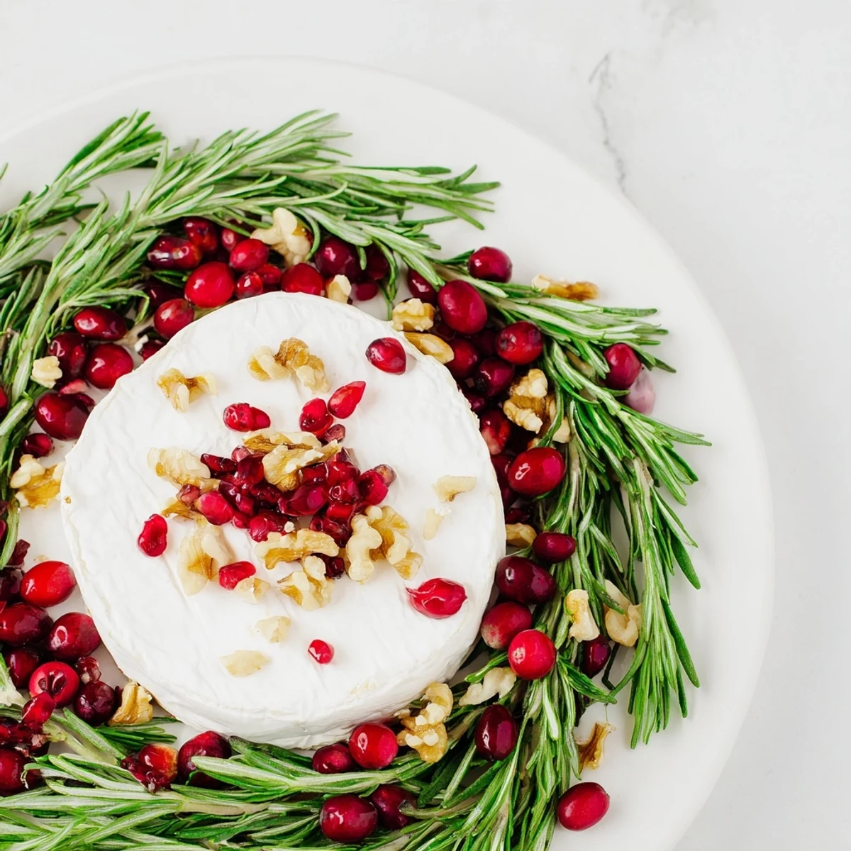 Creamy Brie Cheese Wheel with fragrant rosemary wreath, ready to serve with crackers and jam.