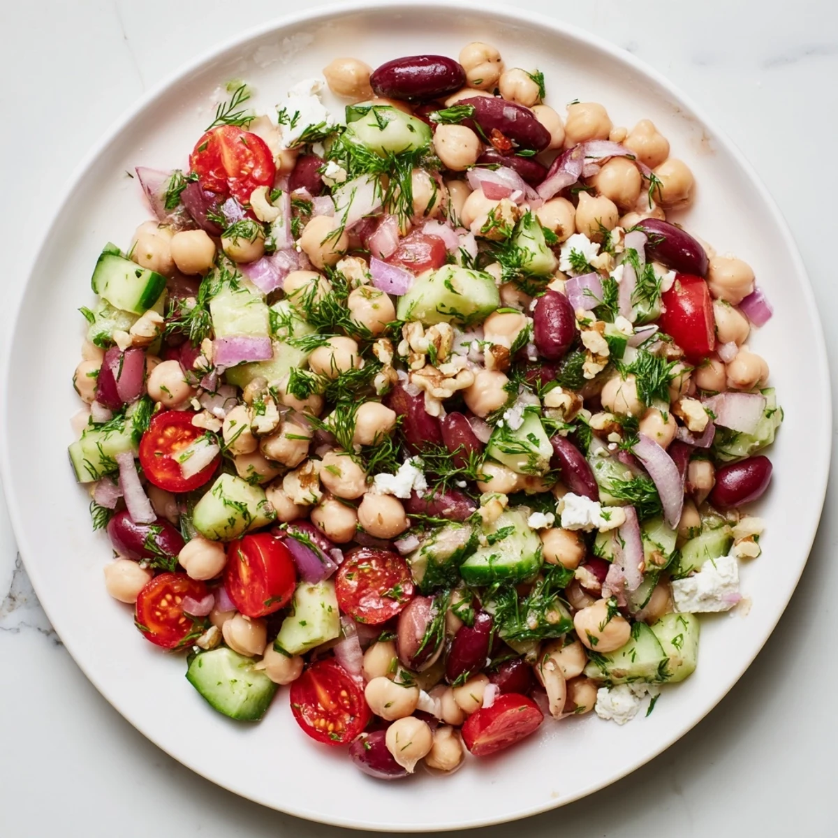 Vibrant Dense Bean Salad, tossed with tart cherry dressing, a delicious and healthy vegetarian meal.