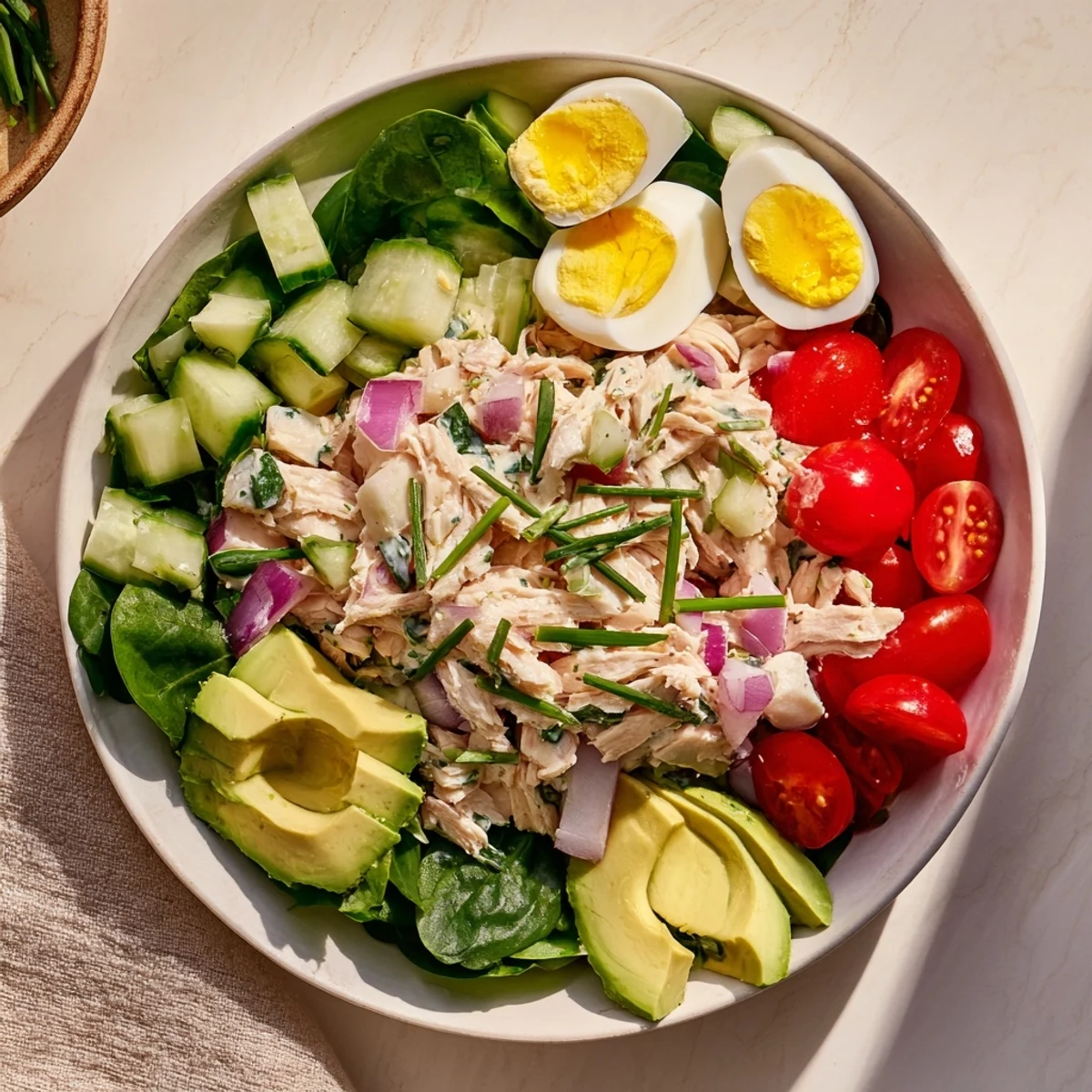 This High-Protein Chicken and Egg Salad features fresh tomatoes and a tangy mustard dressing.