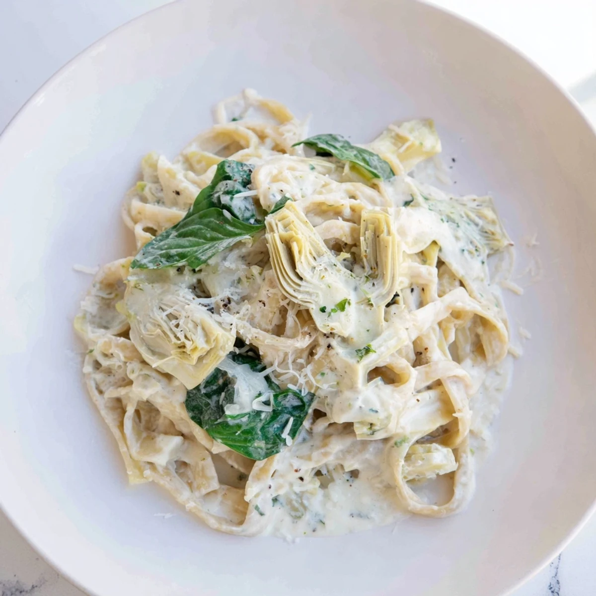 Creamy Lemon Artichoke Pasta, a bright, inviting bowl with creamy sauce and pasta.