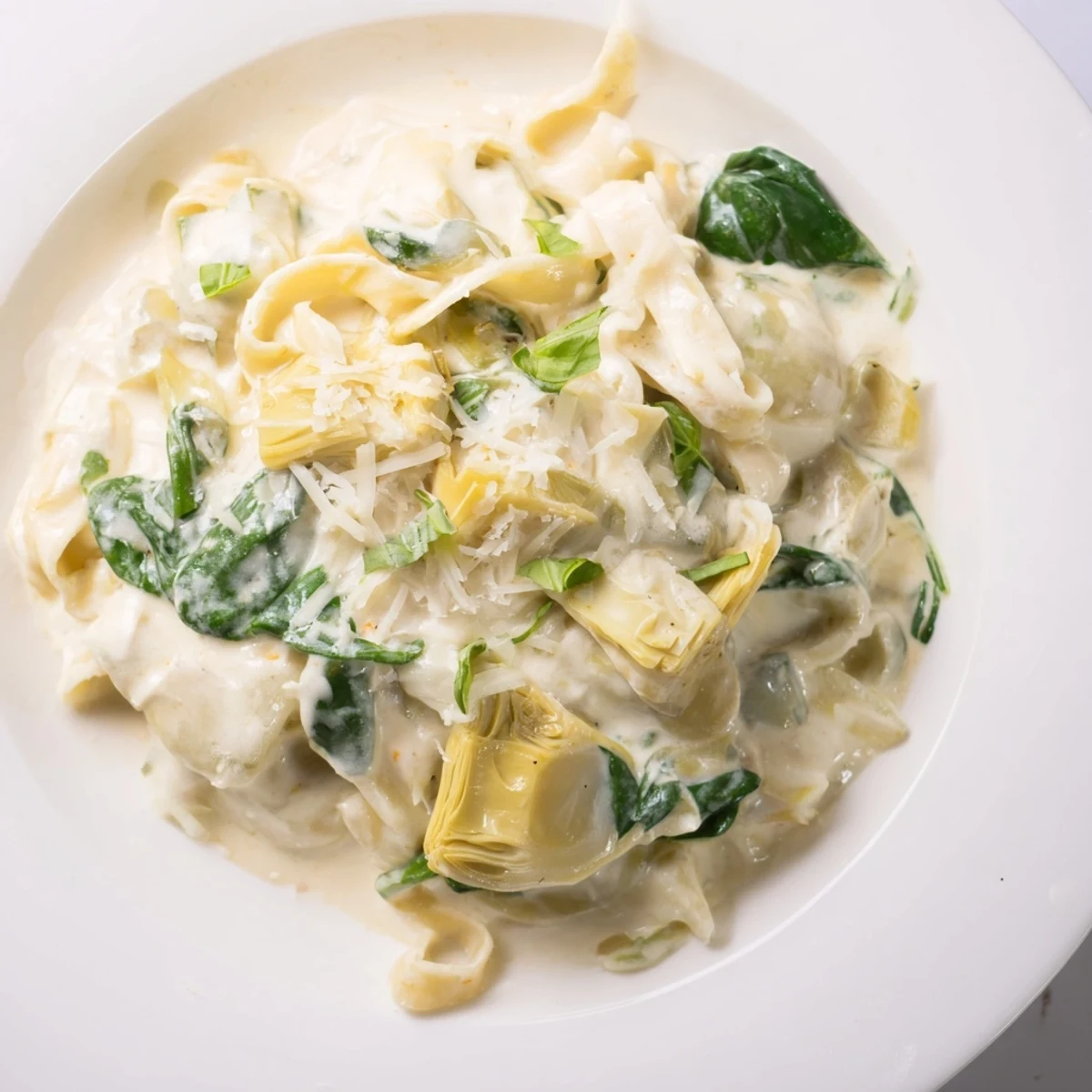 Delicious Italian Creamy Lemon Artichoke Pasta, with artichokes and parmesan cheese, a great dinner.