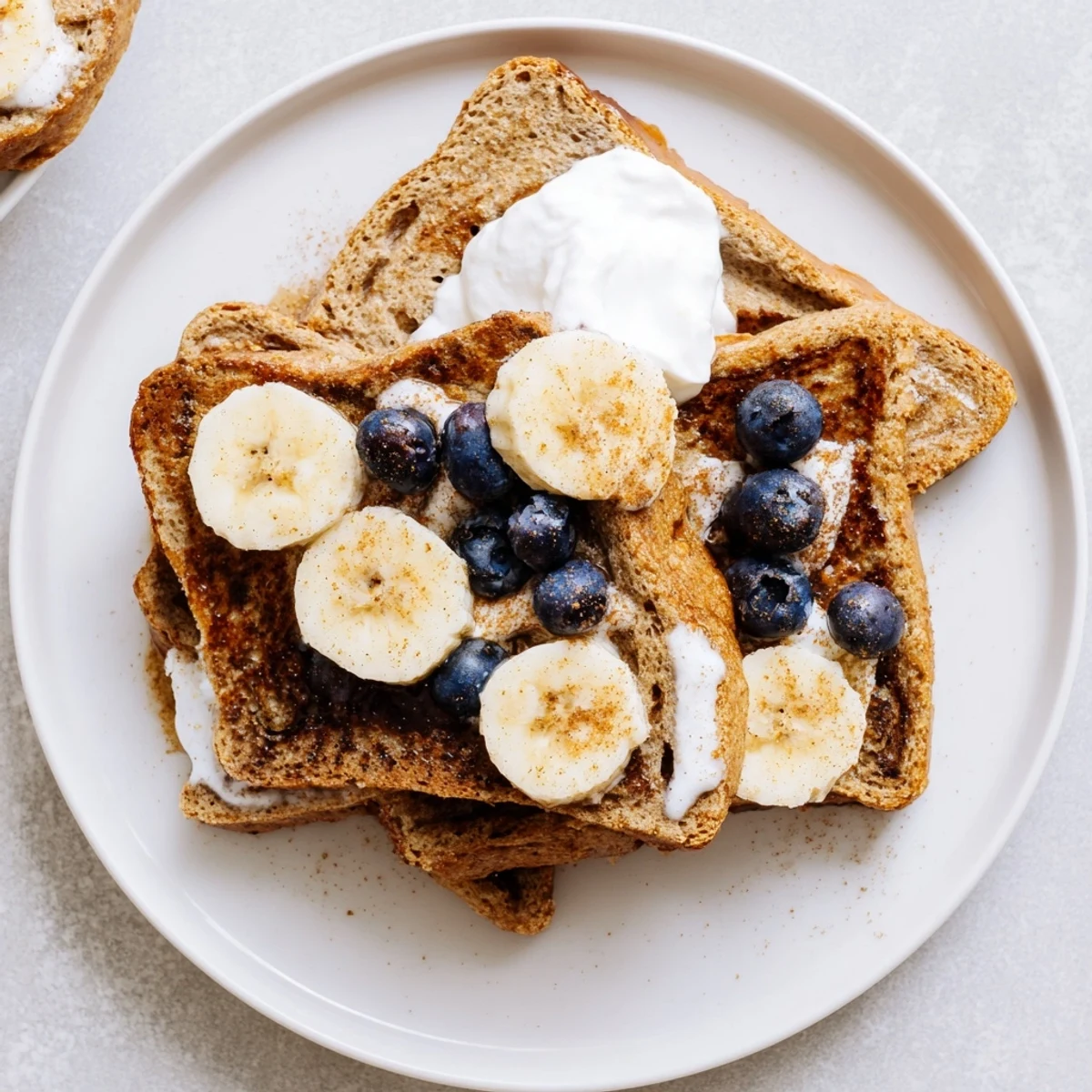 Warm and fluffy Protein French Toast, cooked to a perfect golden brown, ready to enjoy with syrup.