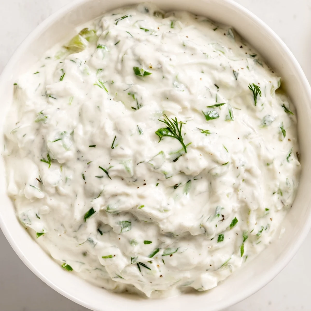 Fresh vegetables surround creamy Greek Yogurt Ranch Dip, bursting with tangy herb flavors, ready to enjoy.