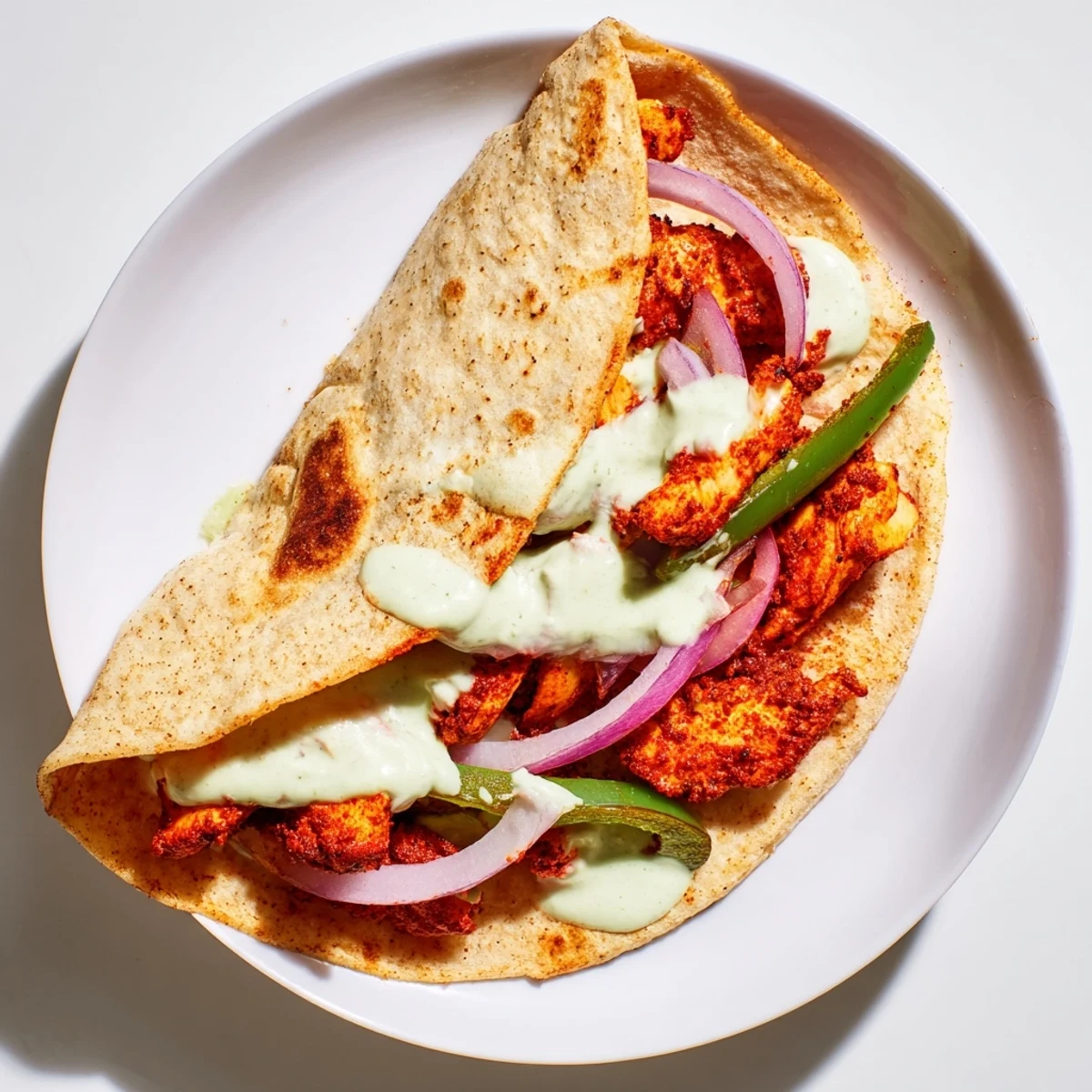 Crispy, golden-brown Tandoori Chicken Quesadilla, sliced and ready to serve with creamy yogurt dipping sauce.