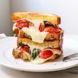 Golden-brown Air Fryer Pizza Margherita Grilled Cheese, oozing with cheese and fresh basil, a delicious Italian-American meal.