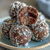 A vibrant stack of no-bake hojicha energy balls, showcasing the earthy green tea hue and wholesome ingredients like dates and almonds.  