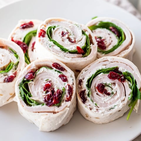 Delectable close-up of colorful Turkey Cranberry Pinwheels, ready to serve as a perfect party appetizer.