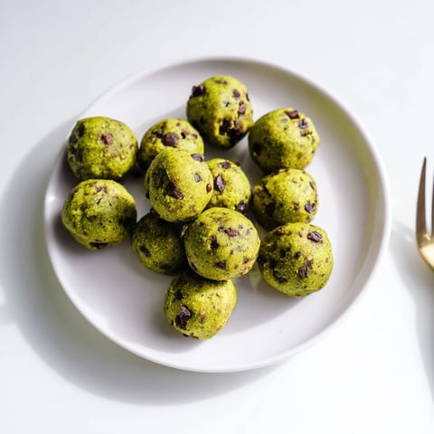 Matcha Gingerbread Cookie Dough Protein Bites, rolled into perfect spheres, look delicious for a snack.