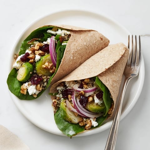 Golden roasted Brussels sprouts and cranberry grain wrap, with a drizzle of balsamic glaze, ready to eat.