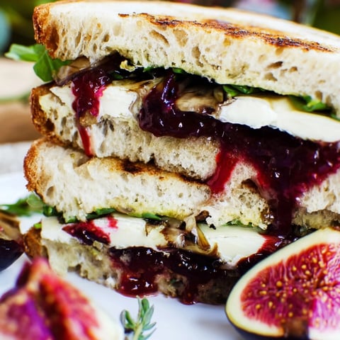 Golden-brown Fig, Brie & Arugula Grilled Cheese, oozing with melted Brie and sweet fig preserves.