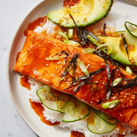 Emily Mariko-inspired sticky orange gochujang salmon bowl, with glistening salmon and vibrant toppings, ready to eat.