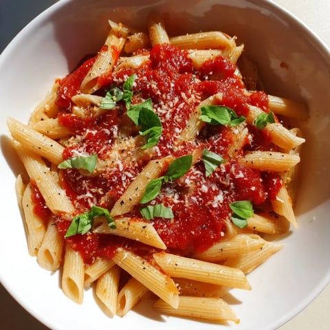 Steaming bowl of Microwave Bowl Pasta, coated in rich marinara, ready to be enjoyed.