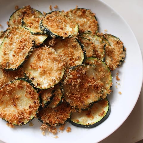 Golden, crispy zucchini chips, air-fried to perfection, are a healthy and delicious snack.