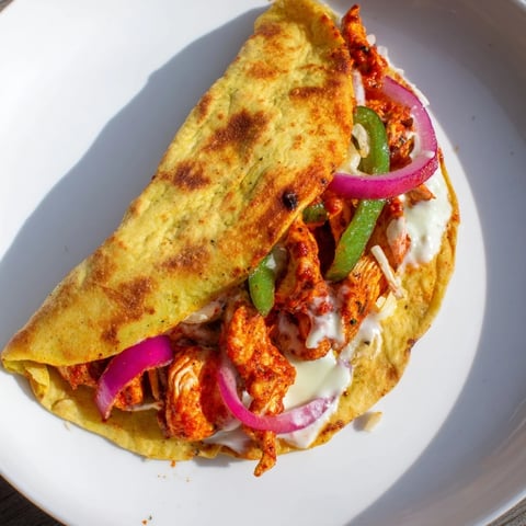 Golden, melty Tandoori Chicken Quesadilla, showcasing juicy spiced chicken and cheese within a crispy tortilla.
