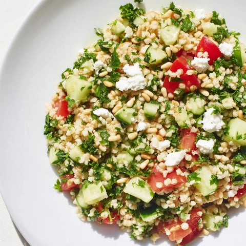 Flavorful Tabbouleh Grain Bowl, overflowing with fresh herbs, a bright lemon dressing, and feta.