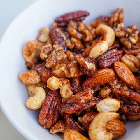 A flavorful bowl of sweet and spicy roasted nuts ideal for party platters.  