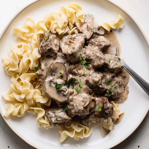 Hearty slow cooker beef stroganoff features rich flavors of mushrooms and sour cream.  
