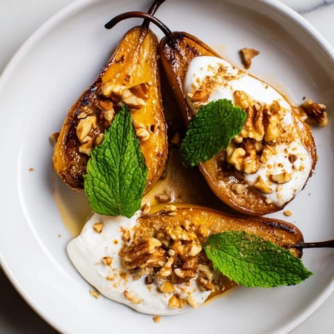 Sweet, tender roasted pears sprinkled with cinnamon, served atop creamy Greek yogurt, and walnuts.