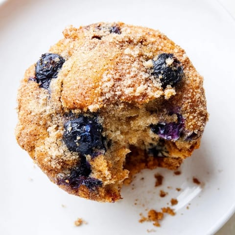 Golden brown Budget Christmas Blueberry Muffins, perfect for a festive breakfast with fresh blueberries and optional topping.
