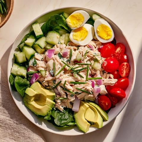 This High-Protein Chicken and Egg Salad features fresh tomatoes and a tangy mustard dressing.
