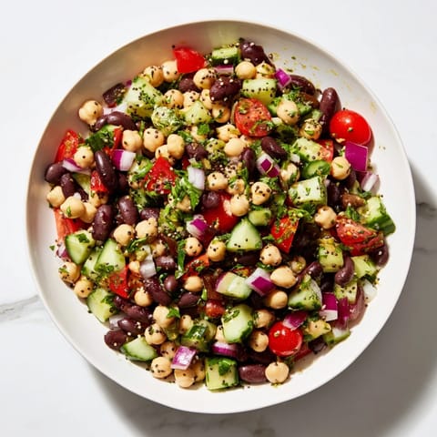 Freshly tossed Dense Bean Salad with visible chia and hemp seeds promising delicious textures in every bite.
