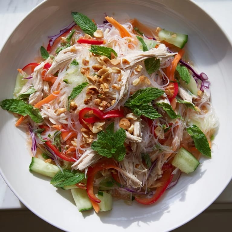 Freshly tossed Vietnamese Crunch Noodle Salad with chicken, topped with crunchy peanuts and herbs.