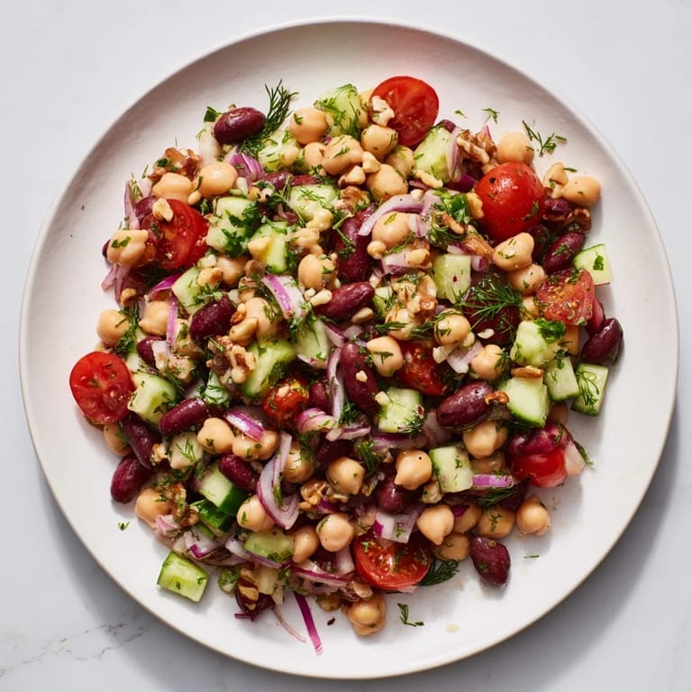 A close-up of a colorful Dense Bean Salad with Sleepy Girl dressing featuring fresh ingredients.