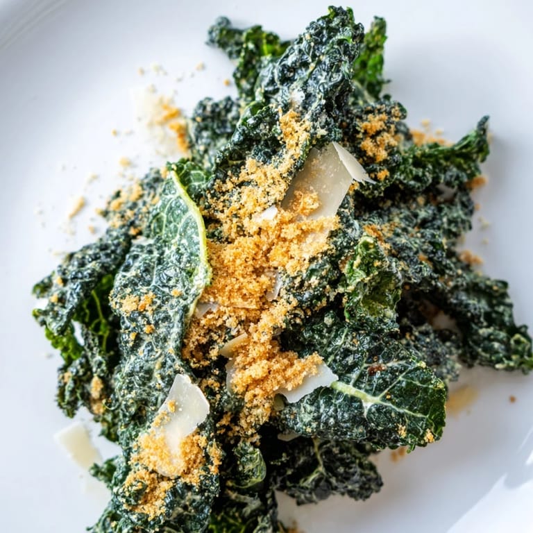 A vibrant Garlic Parmesan Kale Salad served as a light lunch, featuring shaved Parmesan and a zesty lemon-garlic flavor.