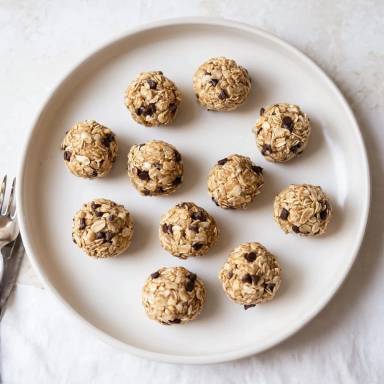 A batch of no-bake Banana Chocolate Chip Energy Balls in a glass jar, perfect for healthy on-the-go snacking.