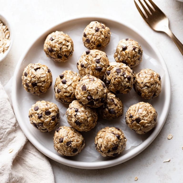 Banana Chocolate Chip Energy Balls arranged on a cooling rack, featuring rolled oats and a hint of maple sweetness.