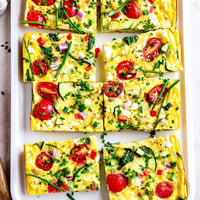 Freshly baked High-Protein Sheet Pan Eggs With Cottage Cheese and Veggies, featuring fluffy golden edges and colorful diced vegetables.